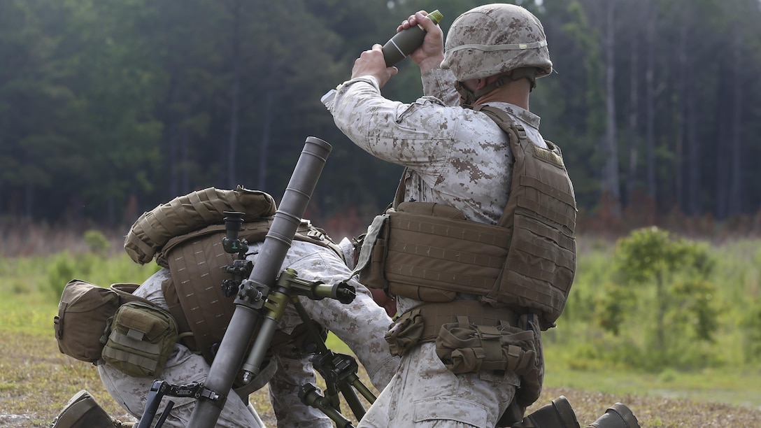 Two artillery Marines fire off a round in the direction indicated by the squad leaders participating in the 2nd Marine Division Infantry Rifle Squad Competition aboard Camp Lejeune, N.C., June 18, 2015. Alpha Company, 1st Battalion, 2nd Marine Regiment; Bravo Company, 1st Battalion, 6th Marine Regiment and India Company, 3rd Battalion, 8th Marine Regiment proved their mission readiness and superior combat abilities while competing in a grueling three-day competition to foster a competitive spirit and unit cohesion and to determine the most proficient and capable rifle squad in 2nd Marine Division. (U.S. Marine Corps photo by Cpl. Michelle Reif/Released)