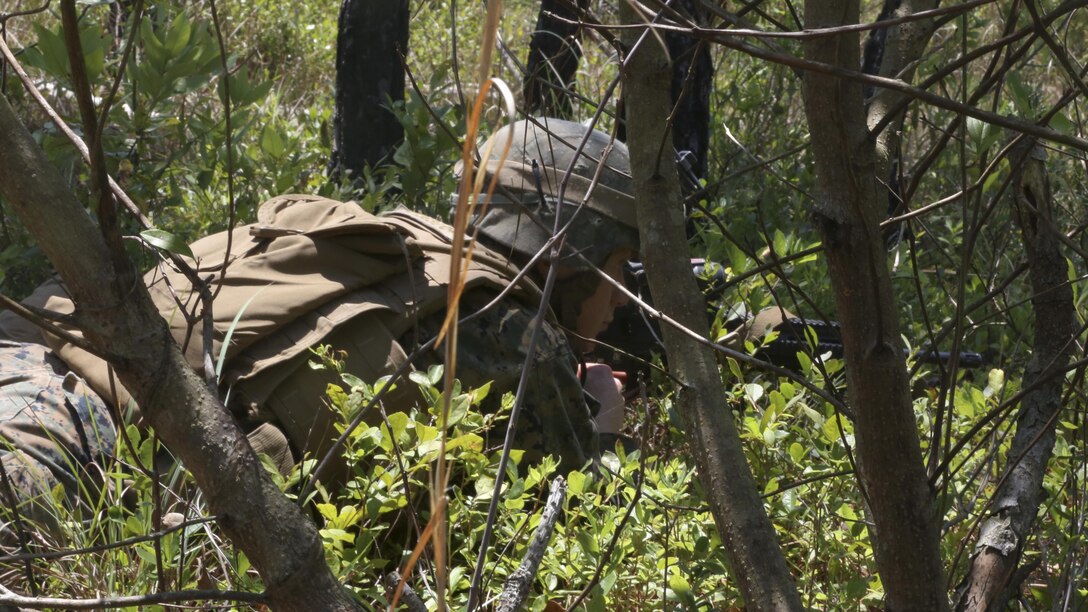 A Marine guards the perimeter of his squad’s defensive position during the 2nd Marine Division Infantry Rifle Squad Competition aboard Camp Lejeune, N.C., June 19, 2015. Alpha Company, 1st Battalion, 2nd Marine Regiment; Bravo Company, 1st Battalion, 6th Marine Regiment and India Company, 3rd Battalion, 8th Marine Regiment proved their mission readiness and superior combat abilities while competing in a grueling three-day competition to foster a competitive spirit and unit cohesion and to determine the most proficient and capable rifle squad in 2nd Marine Division. (U.S. Marine Corps photo by Cpl. Michelle Reif/Released)