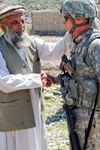 Haji Hazrat Ali Gul says farewell to Army Master Sgt. Bill Dunbar, processing specialist for the 734th Agribusiness Development Team, Iowa National Guard, as Dunbar and other members of the ADT prepare to depart after checking on orchard training for high school students from the Shegal District at the Bar Chage Demonstration Farm north of Asadabad, Afghanistan, April 23, 2011. Gul owns the land the demo farm is on and worked with Dunbar to make it a fruit-production training site for high school students.