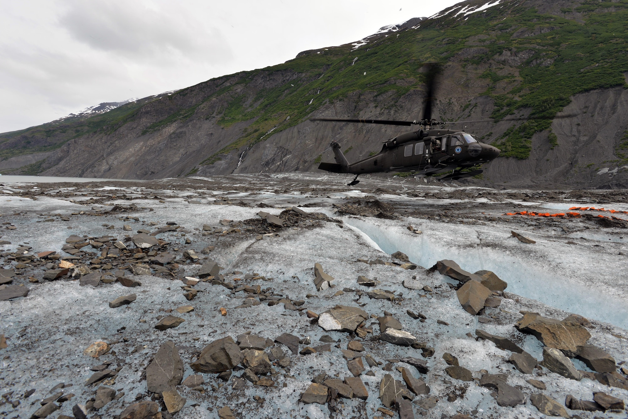 An Alaska National Guard UH-60 Black Hawk lands on Colony Glacier June 10, 2015, in order to transport service members back to Joint Base Elmendorf-Richardson, Alaska. Each summer since 2012, Alaskan Command has supported Operation Colony Glacier by removing aircraft debris and assisting in the recovery of human remains from the 1952 C-124 Globemaster II accident to ensure closure for families who have lost loved ones. (U.S. Air Force photo/Tech. Sgt. John Gordinier)