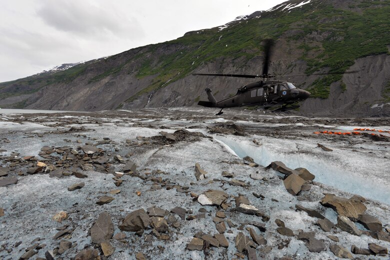 An Alaska National Guard UH-60 Black Hawk lands on Colony Glacier June 10, 2015, in order to transport service members back to Joint Base Elmendorf-Richardson, Alaska. Each summer since 2012, Alaskan Command has supported Operation Colony Glacier by removing aircraft debris and assisting in the recovery of human remains from the 1952 C-124 Globemaster II accident to ensure closure for families who have lost loved ones. (U.S. Air Force photo/Tech. Sgt. John Gordinier)