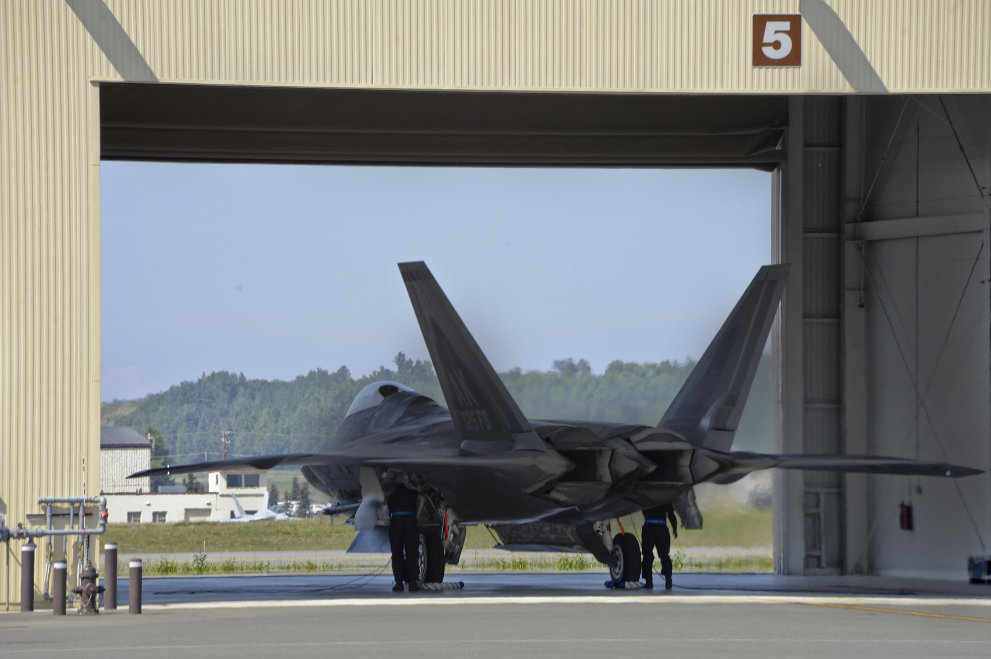 Crewmembers work on an F-22 Raptor from the 525 Fighter Squadron, after it returns from a mission during exercise Northern Edge 2015 at Joint Base Elmendorf-Richardson, Alaska, June 18, 2015. Northern Edge is Alaska’s premier joint training exercise designed to practice operations, techniques and procedures, as well as enhance interoperability among the services. (U.S. Air Force photo/Staff Sgt. William Banton)