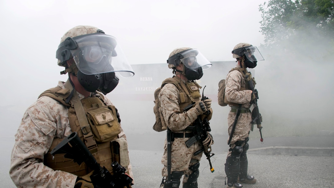 U.S. Marine Cpl. Charles Carlile, left, a member of Special-Purpose Marine Air-Ground Task Force Crisis Response-Africa, holds a defensive line at the National Gendarmerie Training Center in St. Astier, France, June 19, 2015. The Marines trained to respond to a host of urban disturbances and maneuvered their teams without verbal communication. 