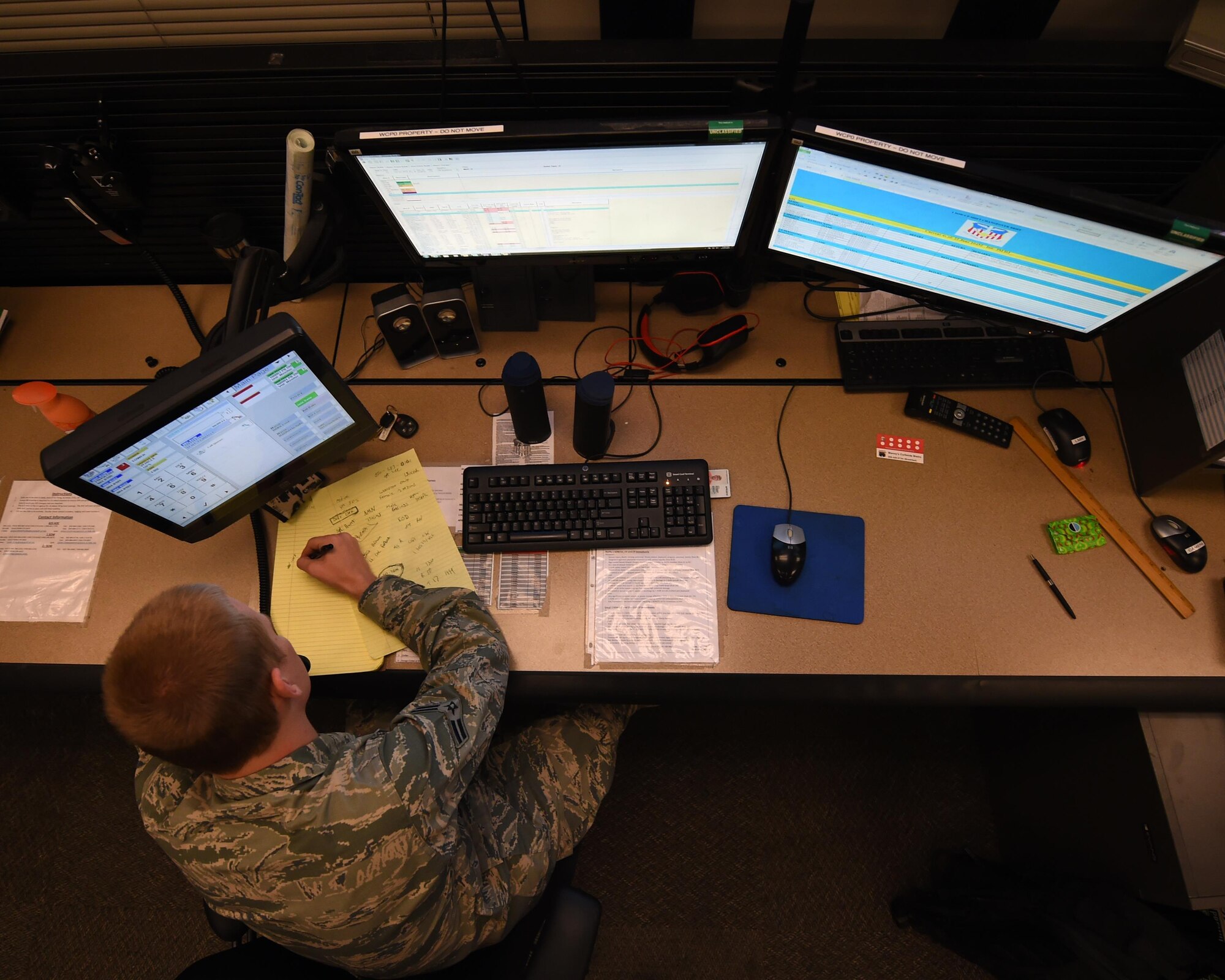 Airman 1st Class Nicholas Eastridge, 1st Special Operations Air Operations Squadron Command Post apprentice controller, transcribes a message, June 22, 2015, at Hurlburt Field, Fla. Airmen assigned to the command post act as a conduit of all communications, acting as a critical asset to base operations and the commander. (U.S. Air Force photo by Airman 1st Class Ryan Conroy/Released)