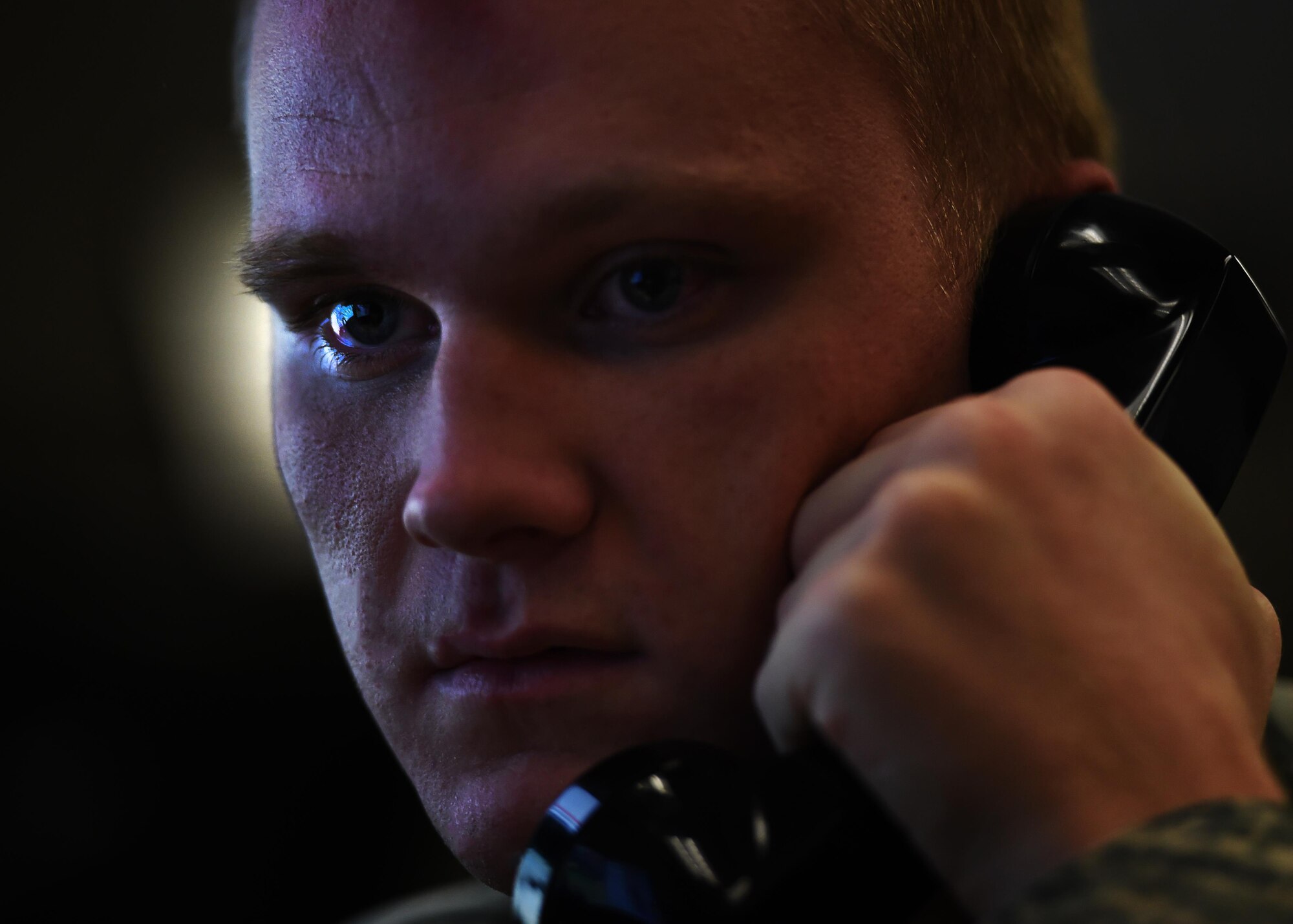 Airman 1st Class Nicholas Eastridge, 1st Special Operations Air Operations Squadron Command Post apprentice controller, communicates with weather operations, June 22, 2015, at Hurlburt Field, Fla. Through the use of communications systems and consoles, the Airmen in the command post are the central nervous system of the base during peacetime, humanitarian and contingency operations. (U.S. Air Force photo by Airman 1st Class Ryan Conroy/Released)