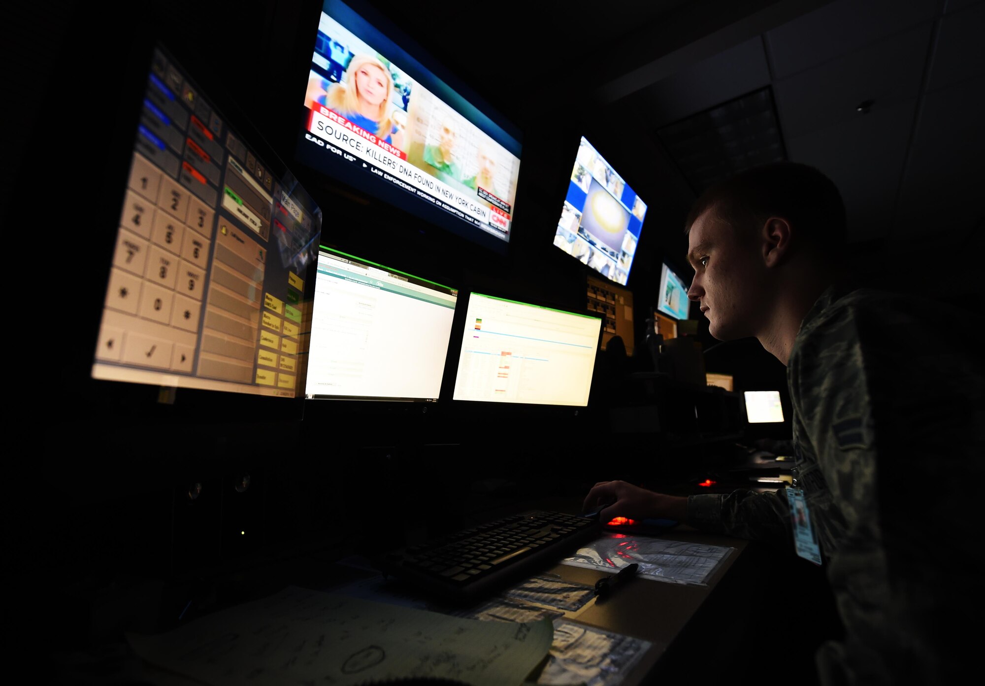 Airman 1st Class Nicholas Eastridge, 1st Special Operations Air Operations Squadron Command Post apprentice controller, updates weather conditions, June 23, 2015, at Hurlburt Field, Fla. Through the use of communications systems and consoles, the Airmen in the Command Post are the central nervous system of the base during peacetime, humanitarian and contingency operations. (U.S. Air Force photo by Airman 1st Class Ryan Conroy/Released)