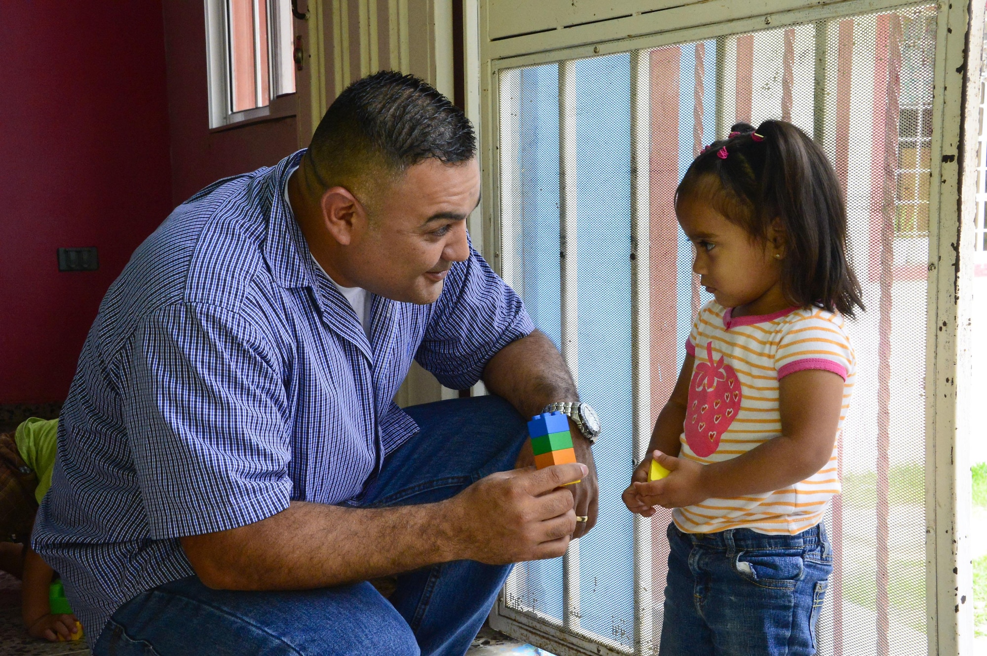 Master Sgt. Roberto Vasquez, the superintendent of 12th Air Force (Air Forces Southern)  Plans, Requirements, and Programs section, plays with a young girl at Casa de Corderitos orphanage outside the city of Tegucigalpa, Honduras, June 18, 2015. Members from 12th Air Force (AFSOUTH) spent some of their downtime during a three-day assessment visit to Honduras air bases to volunteer with the local community and to deliver toys and candy that were donated by businesses in Tucson, Ariz. (U.S. Air Force photo/Tech. Sgt. Heather R. Redman)  