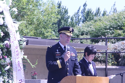 In this file, Major Gen. Thomas R. Tempel, Jr., (left) delivers remarks to those gathered at the 65th Korean War Commemoration held Saturday, June 20, while the retired Sgt. Maj. Jeannie Lee, now the commissioner of the Washington State Commission on Asian Pacific American Affairs, translates.