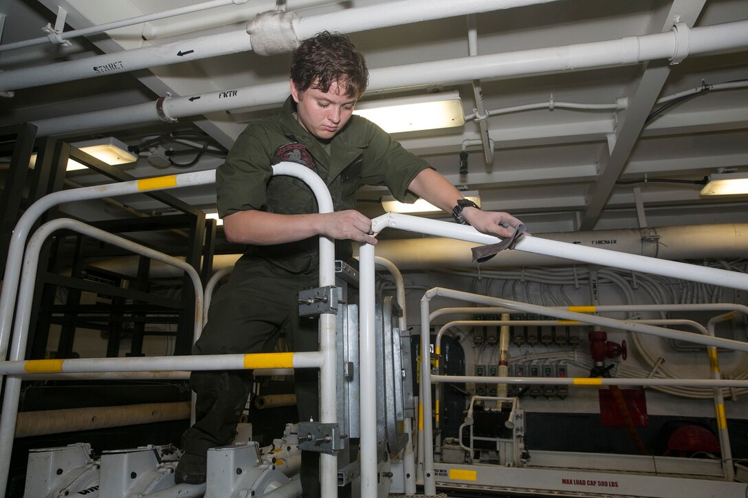 150622-M-SV584-002 ARABIAN SEA (June 22, 2015) U.S. Marine Lance Cpl. Blake Tickle sands rust off a crane during daily maintenance aboard the USS Essex (LHD 2). Tickle is a ground-support equipment mechanic with Combat Logistics Battalion 15, 15th Marine Expeditionary Unit. When equipment starts to rust, the Marines and Sailors sand and repaint it to keep it in the best condition possible. The 15th MEU is embarked on the Essex Amphibious Ready Group and deployed to maintain regional security in the U.S. 5th Fleet area of operations. (U.S. Marine Corps photo by Cpl. Anna Albrecht/Released)