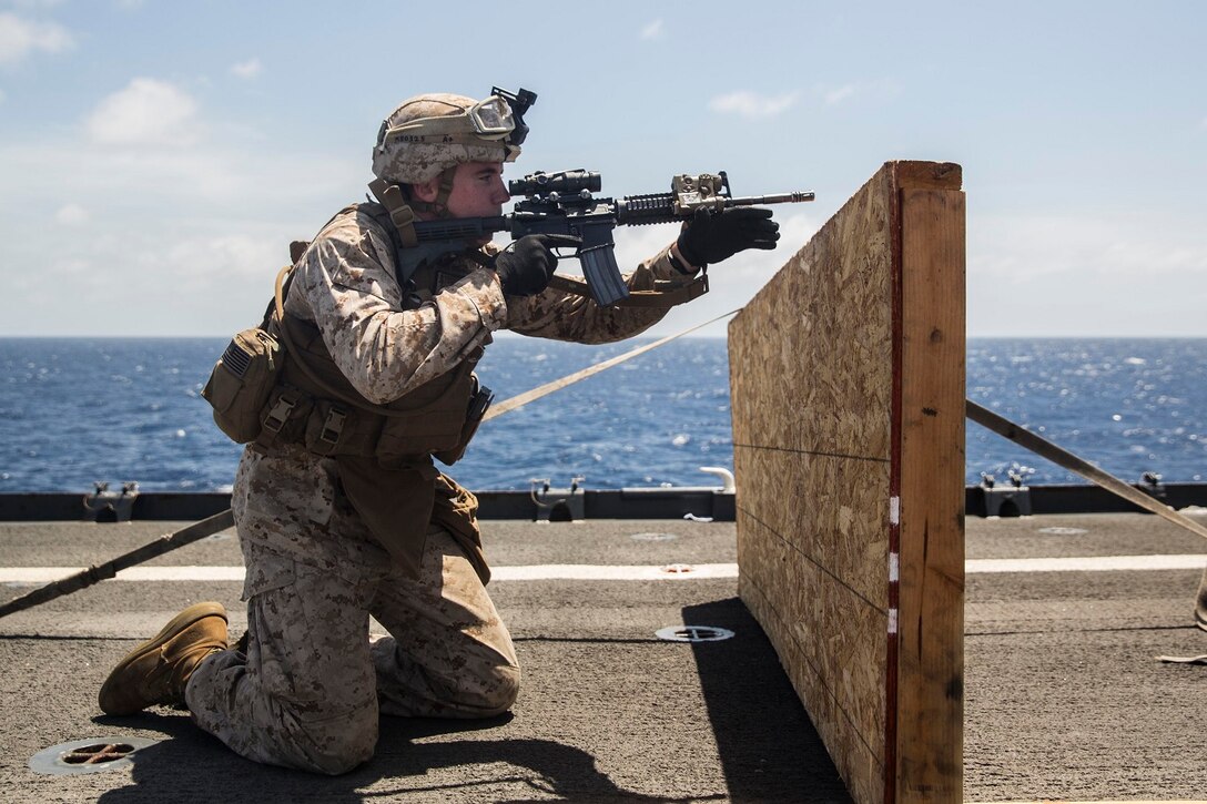 U.S. Marine Lance Cpl. Nicholas Biglione aims at his target during a short-range marksmanship qualification course aboard the USS Rushmore (LSD 47) at sea in the Indian Ocean, June 18, 2015. Biglione is a team leader with Kilo Company, Battalion Landing Team 3rd Battalion, 1st Marine Regiment, 15th Marine Expeditionary Unit. The marksmanship course improves Marine’s combat shooting tactics and prepares them for future operations while deployed with the 15th MEU. (U.S. Marine Corps photo by Sgt. Emmanuel Ramos/Released)