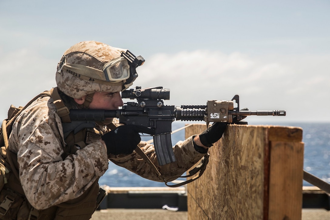 U.S. Marine Lance Cpl. Nicholas Biglione aims at his target during a short-range marksmanship qualification course aboard the USS Rushmore (LSD 47) at sea in the Indian Ocean, June 18, 2015. Biglione is a team leader with Kilo Company, Battalion Landing Team 3rd Battalion, 1st Marine Regiment, 15th Marine Expeditionary Unit. The marksmanship course improves Marine’s combat shooting tactics and prepares them for future operations while deployed with the 15th MEU. (U.S. Marine Corps photo by Sgt. Emmanuel Ramos/Released)