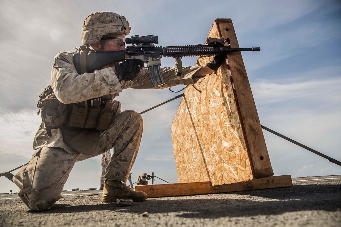 U.S. Marine Lance Cpl. Johnny Przybylo fires at his target during a short-range marksmanship qualification course aboard the USS Rushmore (LSD 47) at sea in the Indian Ocean, June 18, 2015. Przybylo is a rifleman with Kilo Company, Battalion Landing Team 3rd Battalion, 1st Marine Regiment, 15th Marine Expeditionary Unit. The marksmanship course improves Marine’s combat shooting tactics and prepares them for future operations while deployed with the 15th MEU. (U.S. Marine Corps photo by Sgt. Emmanuel Ramos/Released)