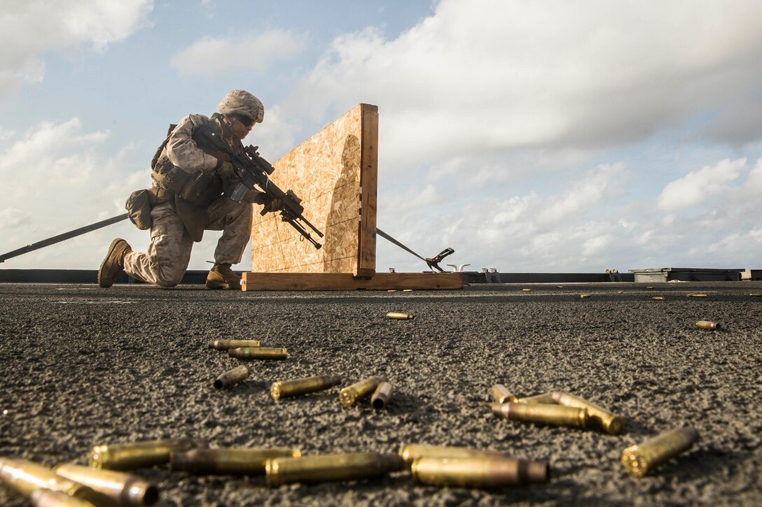 U.S. Marine Lance Cpl. Jose Garcia moves to his next shooting position during a short-range marksmanship qualification course aboard the USS Rushmore (LSD 47) at sea in the Indian Ocean, June 18, 2015. Garcia is a rifleman with Kilo Company, Battalion Landing Team 3rd Battalion, 1st Marine Regiment, 15th Marine Expeditionary Unit. The marksmanship course improves Marine’s combat shooting tactics and prepares them for future operations while deployed with the 15th MEU. (U.S. Marine Corps photo by Sgt. Emmanuel Ramos/Released)