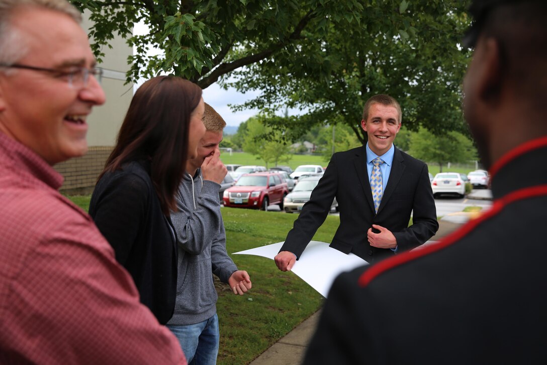 Zachary Dupee, recipient of the prestigious Naval Reserve Officers' Training Corps Scholarship, enjoys a moment with his family and his recruiter after being presented the award, June 2. Zachary is an avid outdoorsman and spends the majority of his time hunting, fishing and hiking. He plans to attend Oregon State University before receiving his commission as a second lieutenant in the United States Marine Corps. (U.S. Marine Corps Photo by Sgt. Tyler C. Vernaza / released)