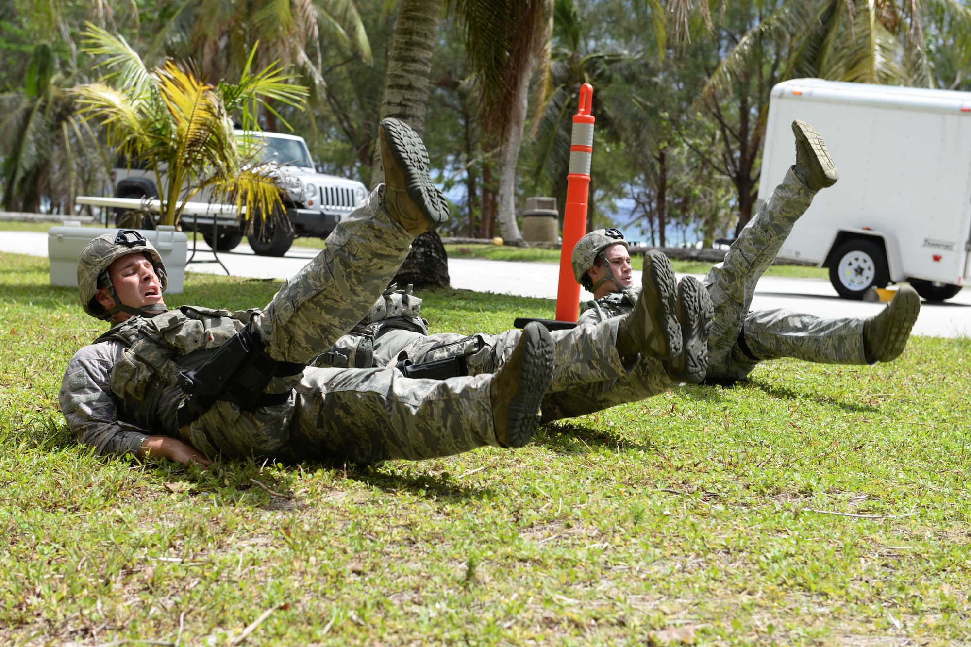 Airmen from the 36th Security Forces Squadron perform flutter kicks during the Defender Challenge June 22, 2015, at Andersen Air Force Base, Guam. Airmen tested their physical and mental strength through various obstacles and challenges during the competition, ending with a live-fire shooting course. (U.S. Air Force photo by Airman 1st Class Joshua Smoot/Released)