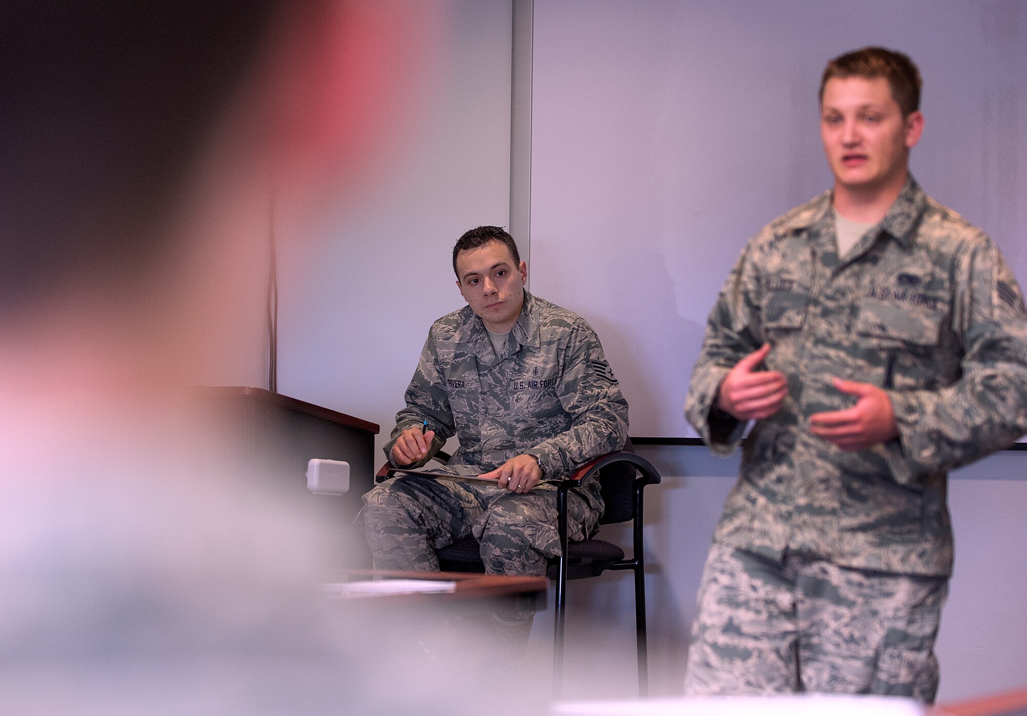 Staff Sgt.  Daniel Rivera, 90th Force Support Squadron Airman Leadership School instructor, listens as a student makes a presentation to his class June 15, 2015, on F.E. Warren Air Force Base, Wyo. The Warren ALS earned a perfect score on a recent program management review conducted by its accreditation board. (U.S. Air Force photo by R.J. Oriez)