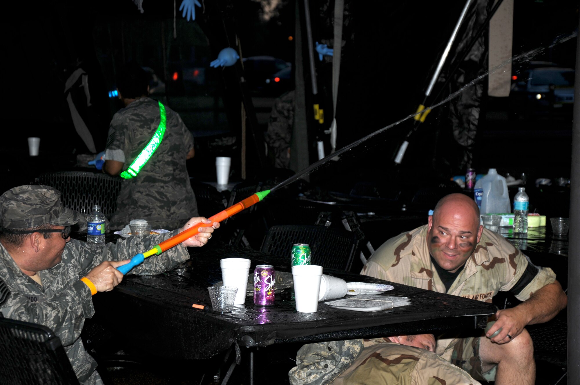 Airmen take cover and return fire during the Enlisted Combat Dining In June 19 at Freedom Park on Columbus Air Force Base, Mississippi. CDIs are one of the Air Force’s most honored traditions, and an experience many Airmen enjoy. (U.S. Air Force photo/Sharon Ybarra)