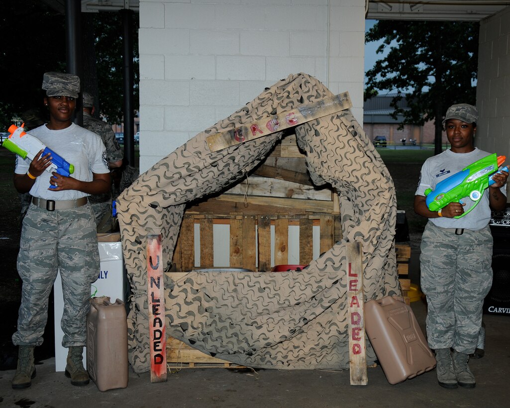 Grog bowls are guarded by Team BLAZE members during the Enlisted Combat Dining In June 19 at Freedom Park on Columbus Air Force Base, Mississippi. The warriors in attendance endured an obstacle course, food and an intense water gun battle. (U.S. Air Force photo/Sharon Ybarra)