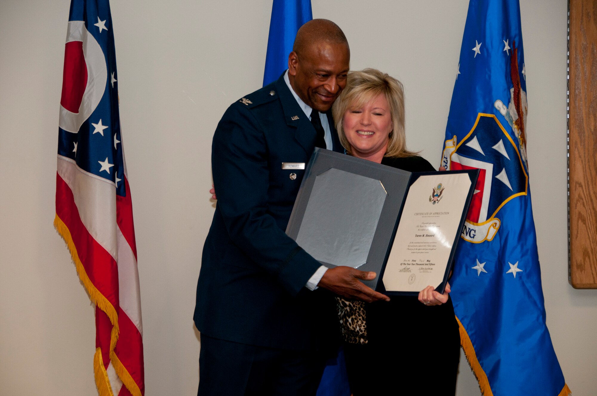 179th Airlift Wing Vice Commander, Col. Michael J. Howard, presents a certificate of appreciation to his spouse, Taren, in Mansfield, Ohio, at his retirement ceremony on April 11, 2015. Howard retires with over 35 years of military service. (U.S. Air National Guard Photo by Tech. Sgt. Joe Harwood\Released)