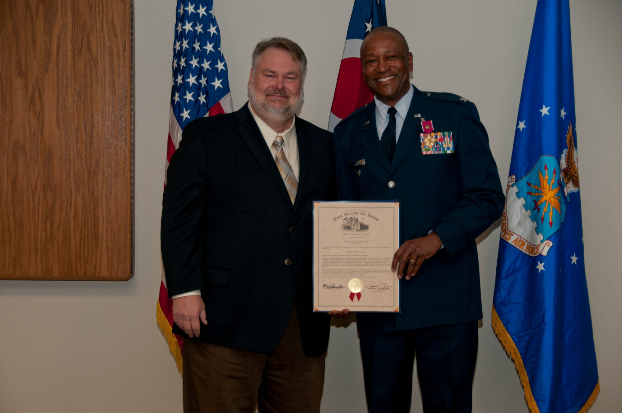Ohio House of Representatives 2nd House District Representative, Mark Romanchuk, presents a certificate thanking Vice Commander, Col. Michael J. Howard in Mansfield, Ohio, at his retirement ceremony on April 11, 2015. Howard retires with over 35 years of military service. (U.S. Air National Guard Photo by Tech. Sgt. Joe Harwood\Released)