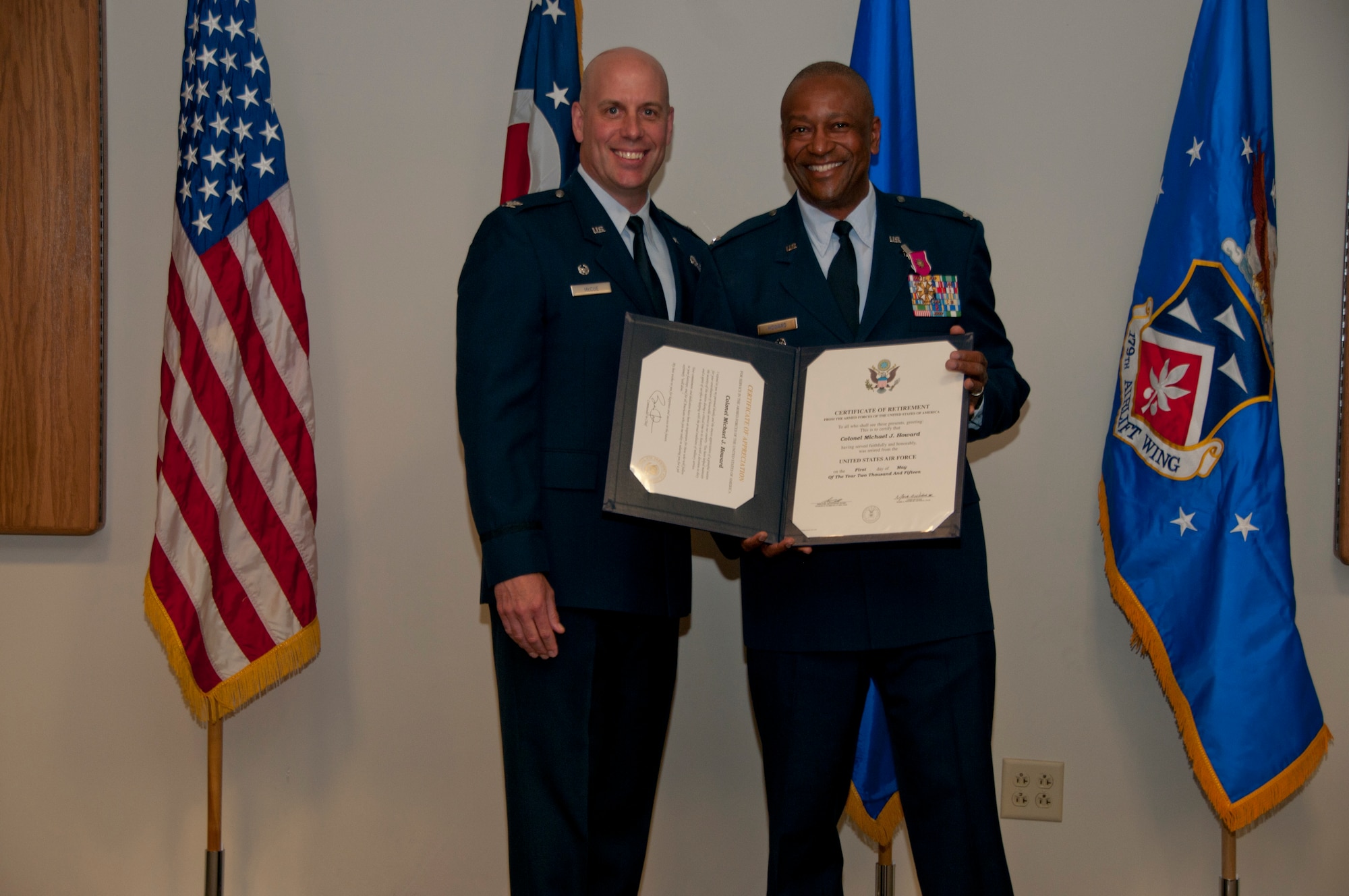 179th Airlift Wing Commander, Col. Gary A. McCue, presents the Legion of Merit to retiring Vice Commander, Col. Michael J. Howard in Mansfield, Ohio, at a retirement ceremony on April 11, 2015. Howard retires with over 35 years of military service. (U.S. Air National Guard Photo by Tech. Sgt. Joe Harwood\Released)