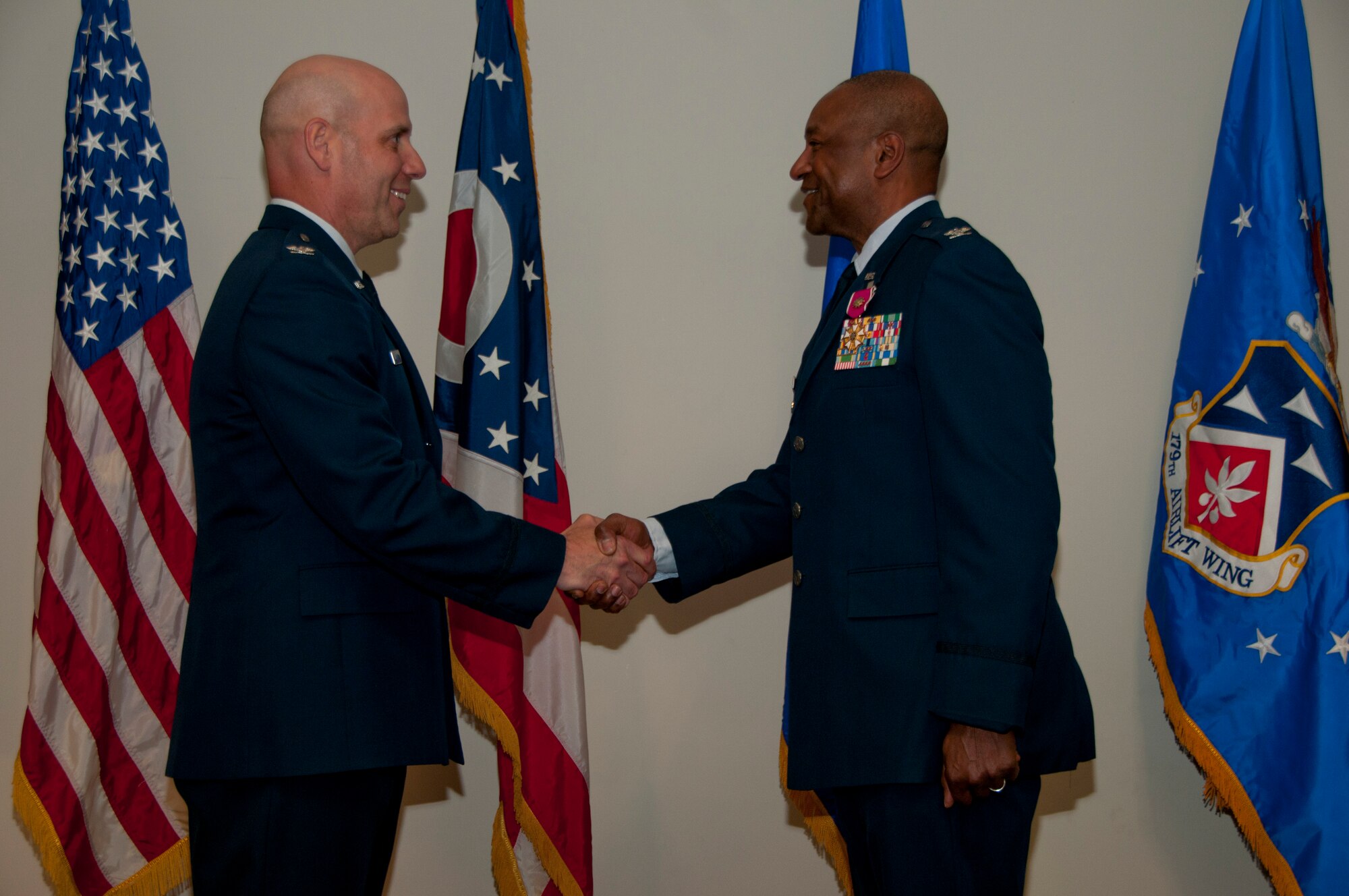 179th Airlift Wing Commander, Col. Gary A. McCue, presents the Legion of Merit to retiring Vice Commander, Col. Michael J. Howard in Mansfield, Ohio, at a retirement ceremony on April 11, 2015. Howard retires with over 35 years of military service. (U.S. Air National Guard Photo by Tech. Sgt. Joe Harwood\Released)
