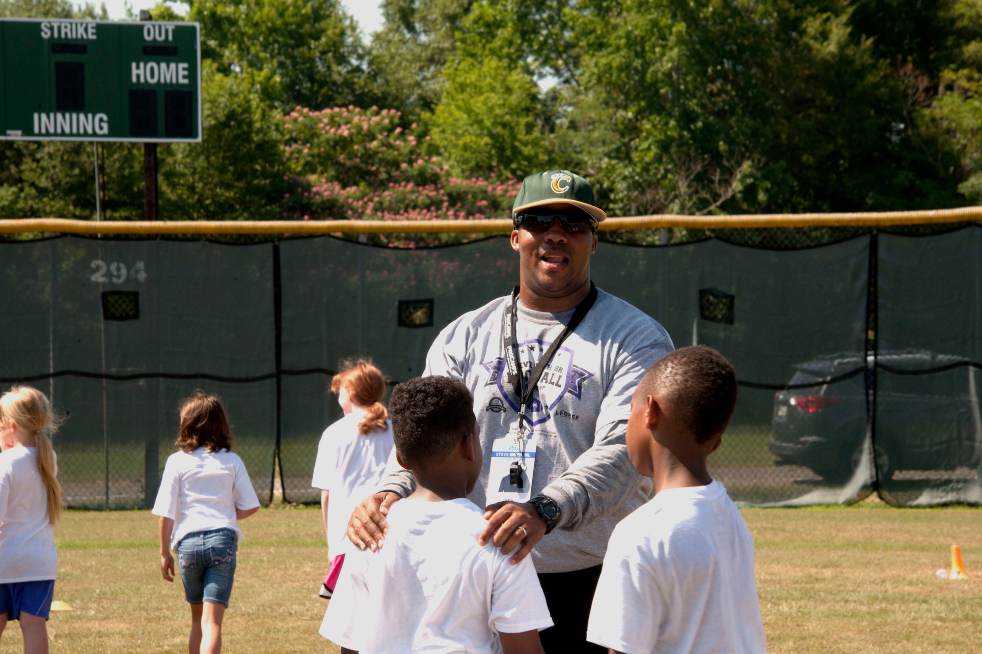 A ProCamp Worldwide youth football coach teaches his team offensive and defensive maneuvers before playing a couple games with National Football League’s Baltimore Ravens wide receiver, Steve Smith Sr., during the youth football camp hosted by the NFL football player, June 22, 2015, at Maxwell Air Force Base, Alabama. Children of military members had the opportunity to learn football, teamwork skills and interact with Smith during the event. (U.S. Air Force photo by Airman 1st Class Alexa Culbert/Cleared)