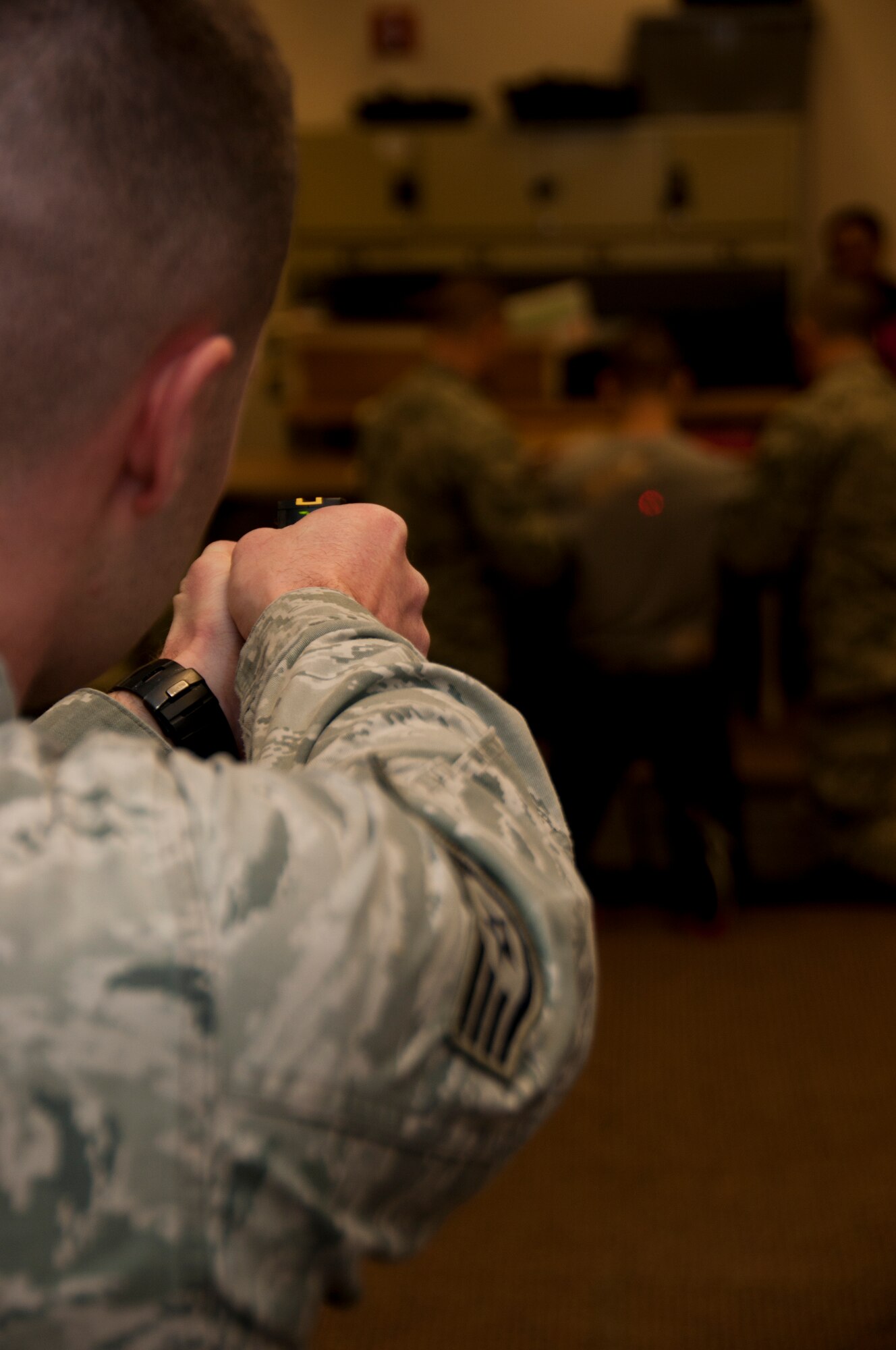 Staff Sgt. Nicholas Alexander administers the taser while members of the 179th Airlift Wing Security Forces Squadron are training on less than lethal methods in Mansfield, OH, Feb. 08, 2015. . (U.S. Air National Guard Photo by Tech. Sgt. Joe Harwood\Released)