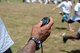 Steve Smith Sr., Baltimore Ravens’ wide receiver, times kids as they speed by during his youth football camp, June 22, 2015, at Maxwell Air Force Base, Alabama. During the camp, children took turns running sprints before getting together to run through a large event banner. (U.S. Air Force photo by Melanie Rodgers Cox/ Cleared) 