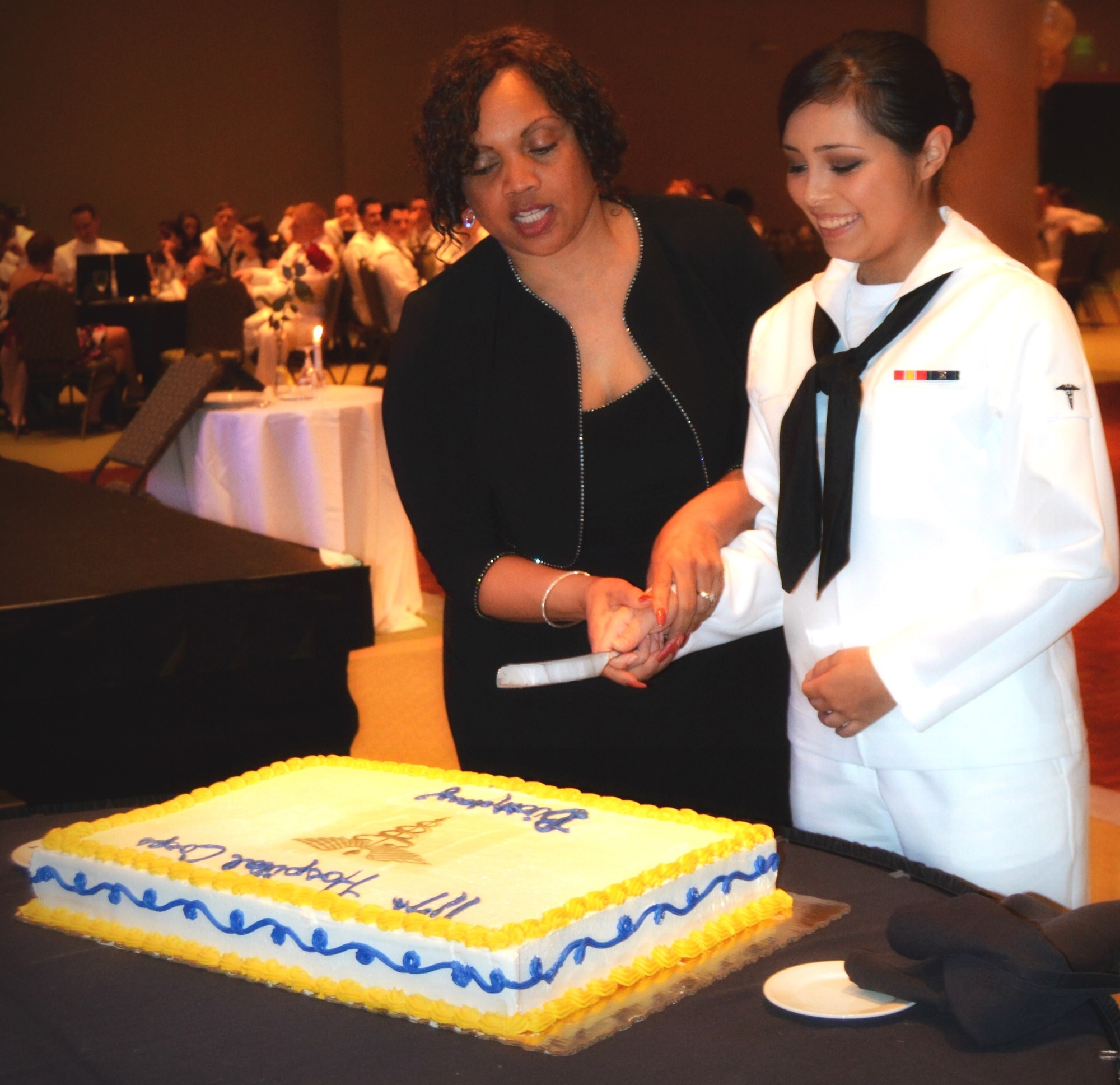 Retired Master Chief Petty Officer Betty Watson, former command master chief of Naval Health Clinic Charleston, and Hospitalman Recruit Brandy Sandova, general hospital corpsman at NHCC, cut a cake celebrating the 117th birthday of the Navy Hospital Corps during the NHCC Corpsman Ball June 13, 2015 at the Culinary Institute of Charleston at Trident Technical College. (Courtesy photos provided by Lyndee Kinard, Kindard's Kreations Portrait Studio)
