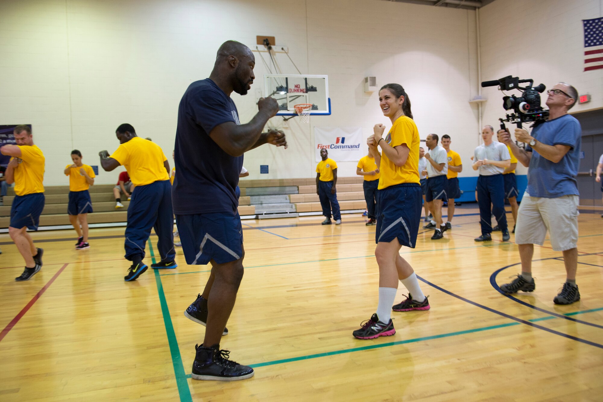 “King Mo” Lawal, a Mixed Martial Arts fighter practices throwing punches with Airmen at the James Gym, Scott Air Force Base, Illinois, June 17, 2015. The fighters taught Airmen fighting techniques and did drills with them. (U.S. Air Force Photo by Airman 1st Class Megan Friedl)