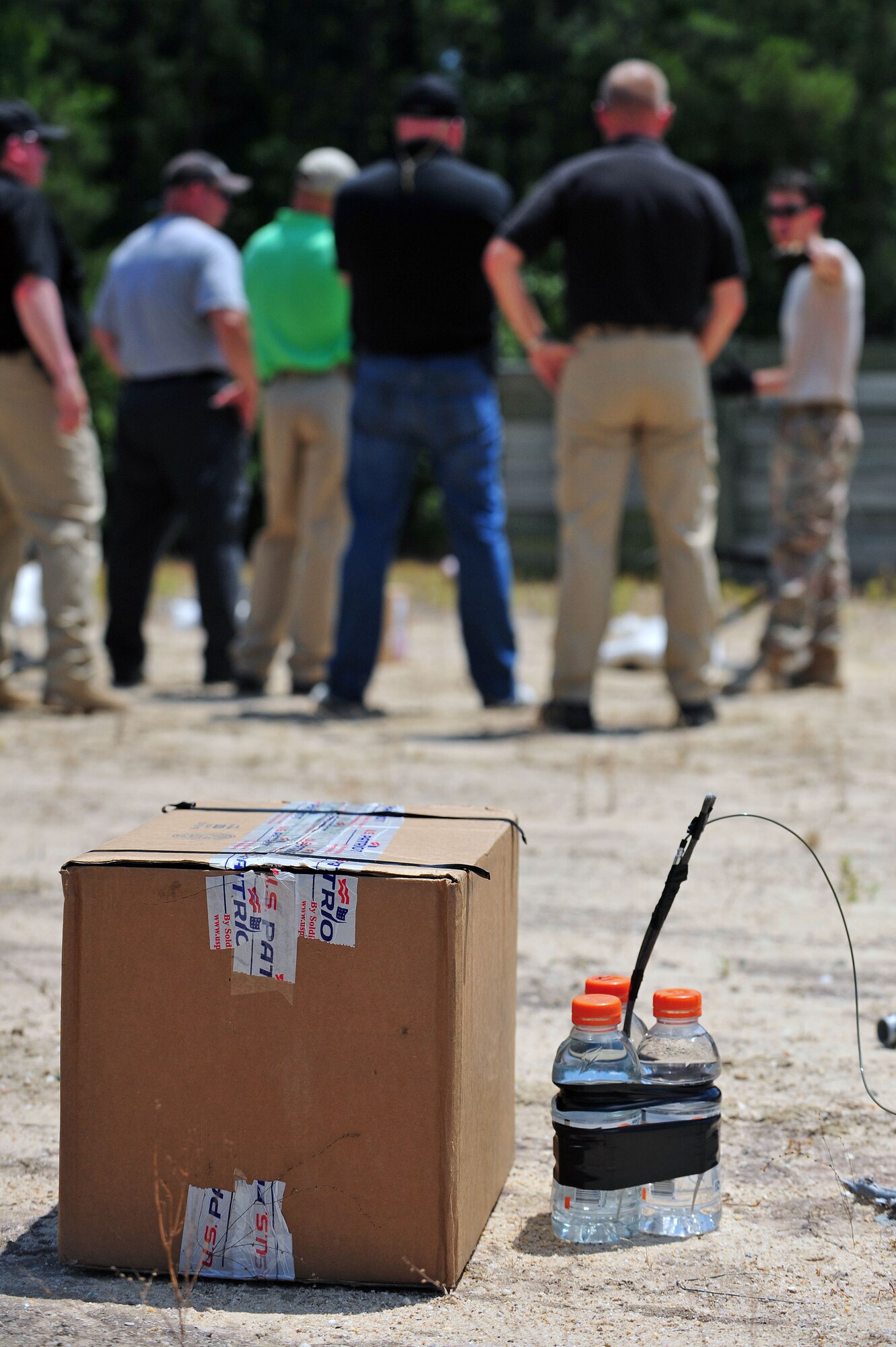 A simulated improvised explosive device lurks near the site of a joint training mission between members of the Wayne County Sheriff’s Office and the 4th Civil Engineer Squadron explosive ordnance disposal flight, June 17, 2015, at Seymour Johnson Air Force Base, North Carolina. An IED is a bomb constructed and employed in ways that differ from conventional military action. (U.S. Air Force photo/Senior Airman John Nieves Camacho)