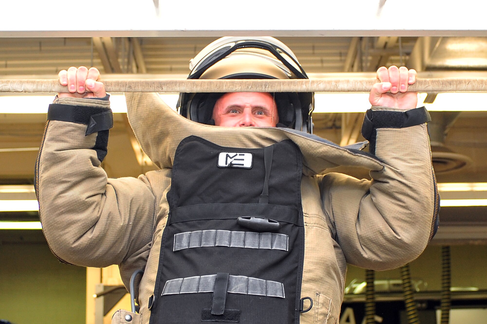 Chris Best, Wayne County Sheriff’s Office patrol deputy, performs pull-ups in a Med-Eng EOD 9 bomb suit during a joint training exercise, June 17, 2015, at Seymour Johnson Air Force Base, North Carolina. The EOD bomb suit provides modular protection and operational flexibility for EOD technicians during chemical, biological, radiological and nuclear missions. (U.S. Air Force photo/Senior Airman John Nieves Camacho)