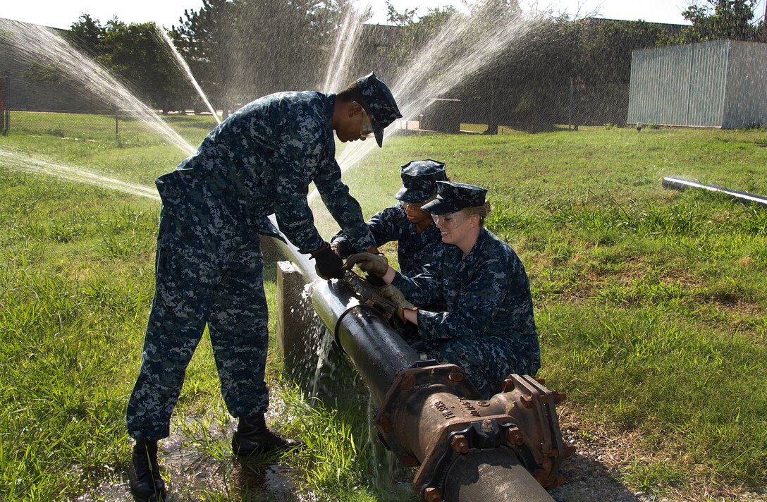 U.S. Navy Sailors assigned to the 366th Training Squadron for training perform emergency repairs to a simulated water main in the Water and Fuel Systems Maintenance Apprentice course at Sheppard Air Force Base, Texas, June 24, 2015. Students in the course learn how to install, inspect, maintain, troubleshoot, modify, and repair potable and waste water systems ensuring they comply with environmental and safety regulations. (U.S. Air
Force photo/Danny Webb/Released)
