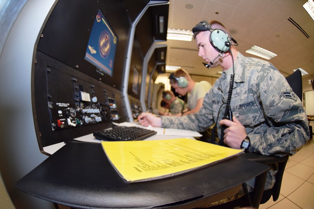 Students train in their initial skills (3-level) course on aircraft communication trainers at Joint Base San Antonio-Lackland, Texas on June 23, 2015 at the 344th Training Squadron.  
They are learning how to properly report an aircraft's latitude and longitude
and estimated time to the next position.   (U.S. Air Force photo/Tech Sgt.
Carlos J. Trevino)
