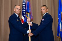 Maj. James Hendrickson assumes command of the 2nd Munitions Squadron from Col. David Foote, 2nd Maintenance Group commander, during a change of command ceremony at Barksdale Air Force Base, La., June 23, 2015. Hendrickson was previously the 36th Munitions Squadron commander at Andersen Air Force Base, Guam, where he was responsible for the maintenance and assembly of all conventional munitions assets in U.S. Pacific Command contingencies and exercises. (U.S. Air Force photo/Senior Airman Benjamin Raughton)