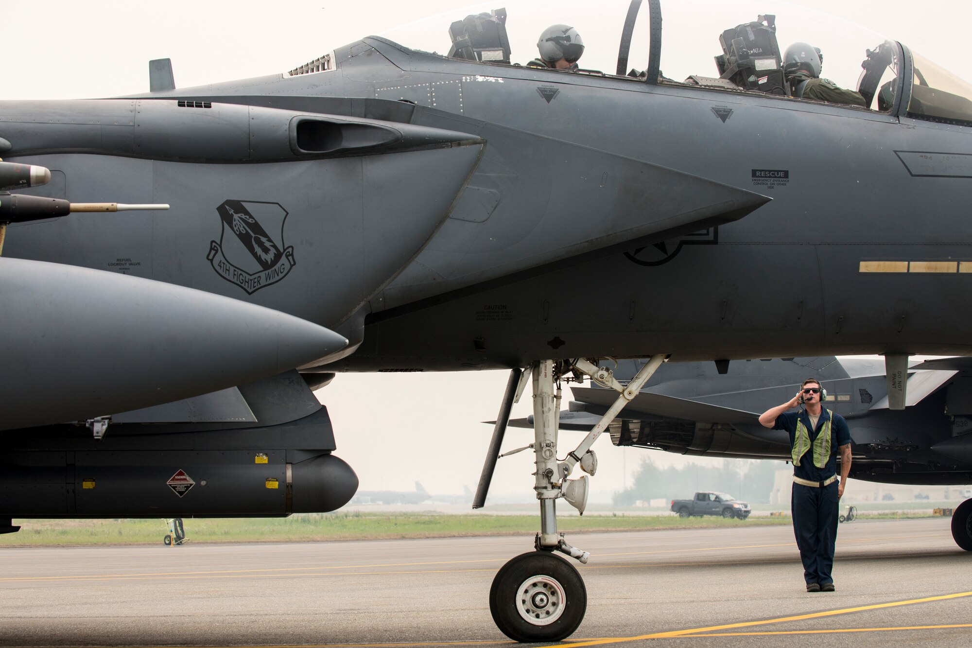 U.S. Air Force Senior Airman Caleb Ross, a 4th Fighter Wing crew chief, salutes an F-15E Strike Eagle pilot assigned to the 4th Fighter Wing, Seymour Johnson Air Force Base, N.C., June 23, 2015, during the Northern Edge 2015 exercise at Eielson Air Force Base, Alaska. Northern Edge 15 is Alaska’s premier joint training exercise designed to practice operations, techniques and procedures as well as enhance interoperability among the services. (U.S. Air Force photo by 1st Lt. Elias Zani/Released)
