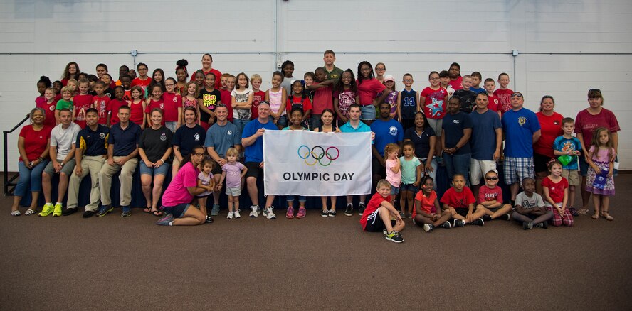 Olympic Day participants, chaperones and volunteers pose for a group photo during Olympic Day June 12, 2015, at Moody Air Force Base, Ga. U.S. Air Force Col. Derek Oaks, center, 23d Fighter Group commander, gave the opening remarks. (U.S. Air Force photo by Senior Airman Ryan Callaghan/Released)