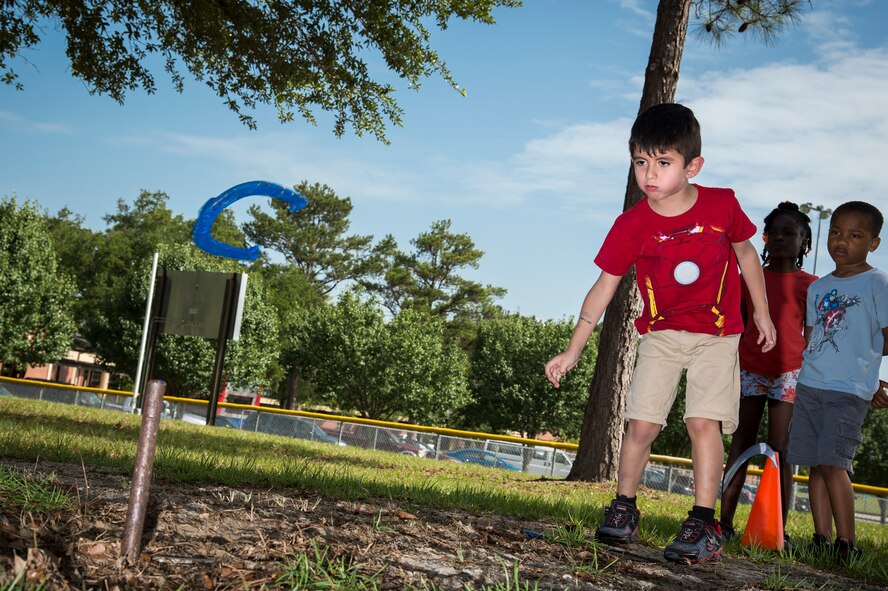 Isiah Segura, a member of Moody’s Youth Programs, tosses a horseshoe during Olympic Day June 12, 2015, at Moody Air Force Base, Ga. In addition to horseshoes, activities included sitting volleyball, bowling, rock wall climbing, beam walk and football throw. (U.S. Air Force photo by Senior Airman Ryan Callaghan/Released)