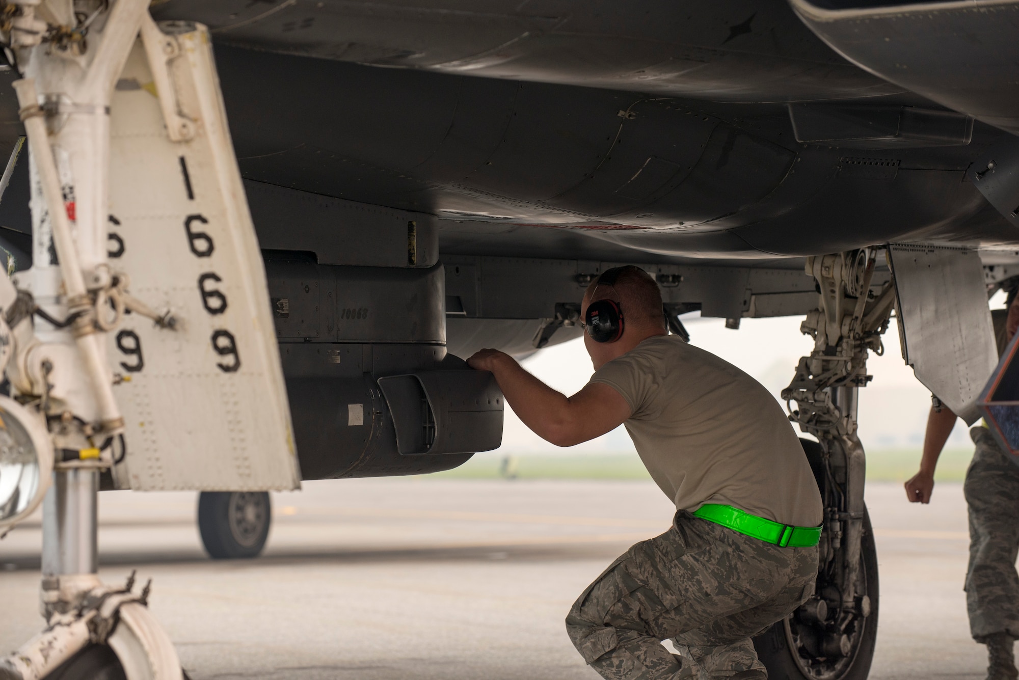 U.S. Air Force Senior Airman Jonathan Mashburn, a 4th Fighter Wing weapons loader, inspects an F-15E Strike Eagle aircraft assigned to the 4th Fighter Wing, Seymour Johnson Air Force Base, N.C., as a part of an end of runway inspection June 23, 2015, during the Northern Edge 2015 exercise at Eielson Air Force Base, Alaska. End of runway inspections allow weapons loaders to ensure the serviceability of on-board weapons prior to takeoff. (U.S. Air Force photo by 1st Lt. Elias Zani/Released)