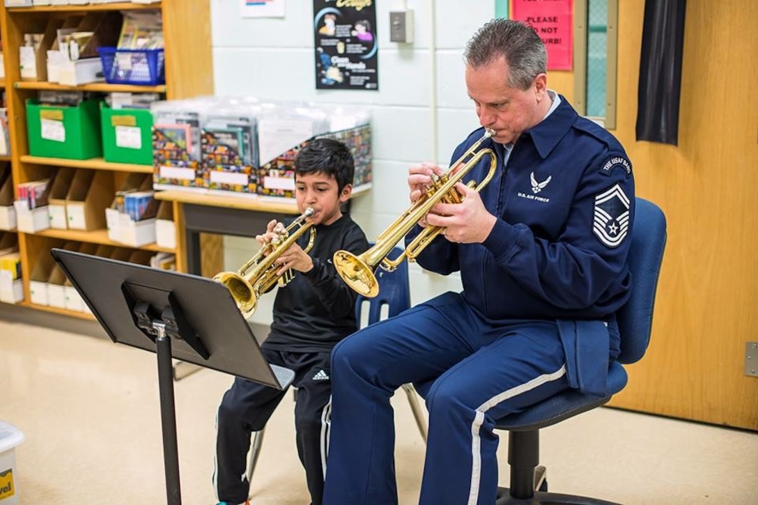 For the entire school year our Advancing Innovation through Music (AIM) program supported local educational outreach program Bridges: Harmony Through Music.  We were honored to be presented the Community Partner of the Year award by founding director Bonny Tynch.  Pictured is Senior Master Sergeant Kevin Burns working with a young trumpet student at a Bridges event.  (U.S. Air Force Photo/released)