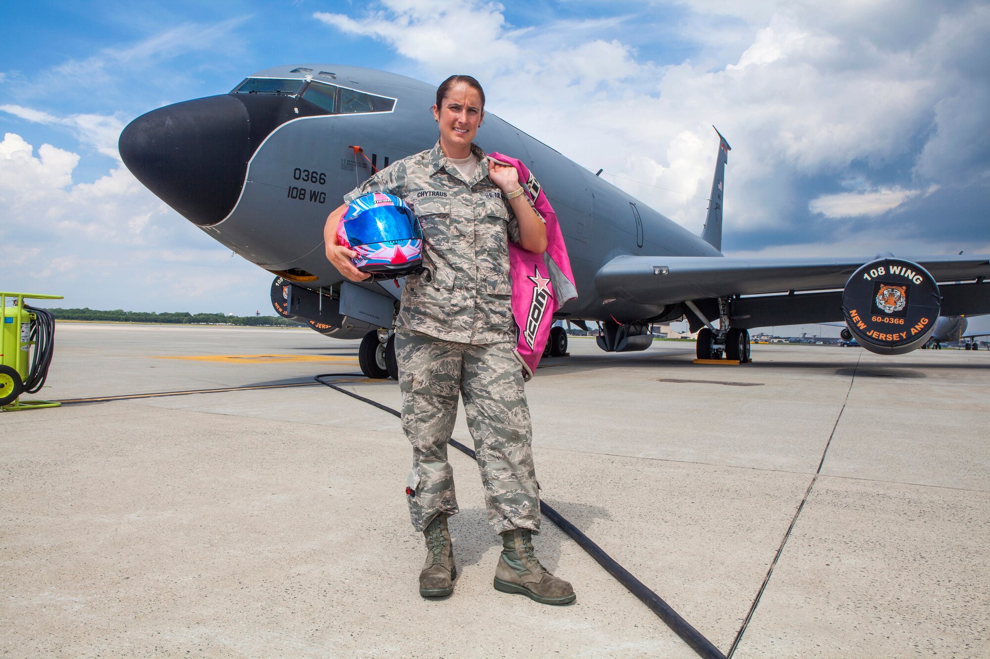Senior Airman Ashley V. Chytraus, a crew chief with the 108th Wing, New Jersey Air National Guard, holds her personal protective equipment in front of a KC-135R Stratotanker at Joint Base McGuire-Dix-Lakehurst, N.J., June 16, 2015. Chytraus was in a motorcycle accident June 21, 2014. The collision broke two vertebrae in Chytraus’s neck, crushed her hand, mangled the quadriceps tendon in her leg, forced two splintered ribs into her liver and fractured her elbow. In addition, she died while being medevaced to the hospital. 358 days later, she passed all portions of the Air Force Physical Fitness Test and received an excellent. (U.S. Air Force photo by Master Sgt. Mark C. Olsen/Released)