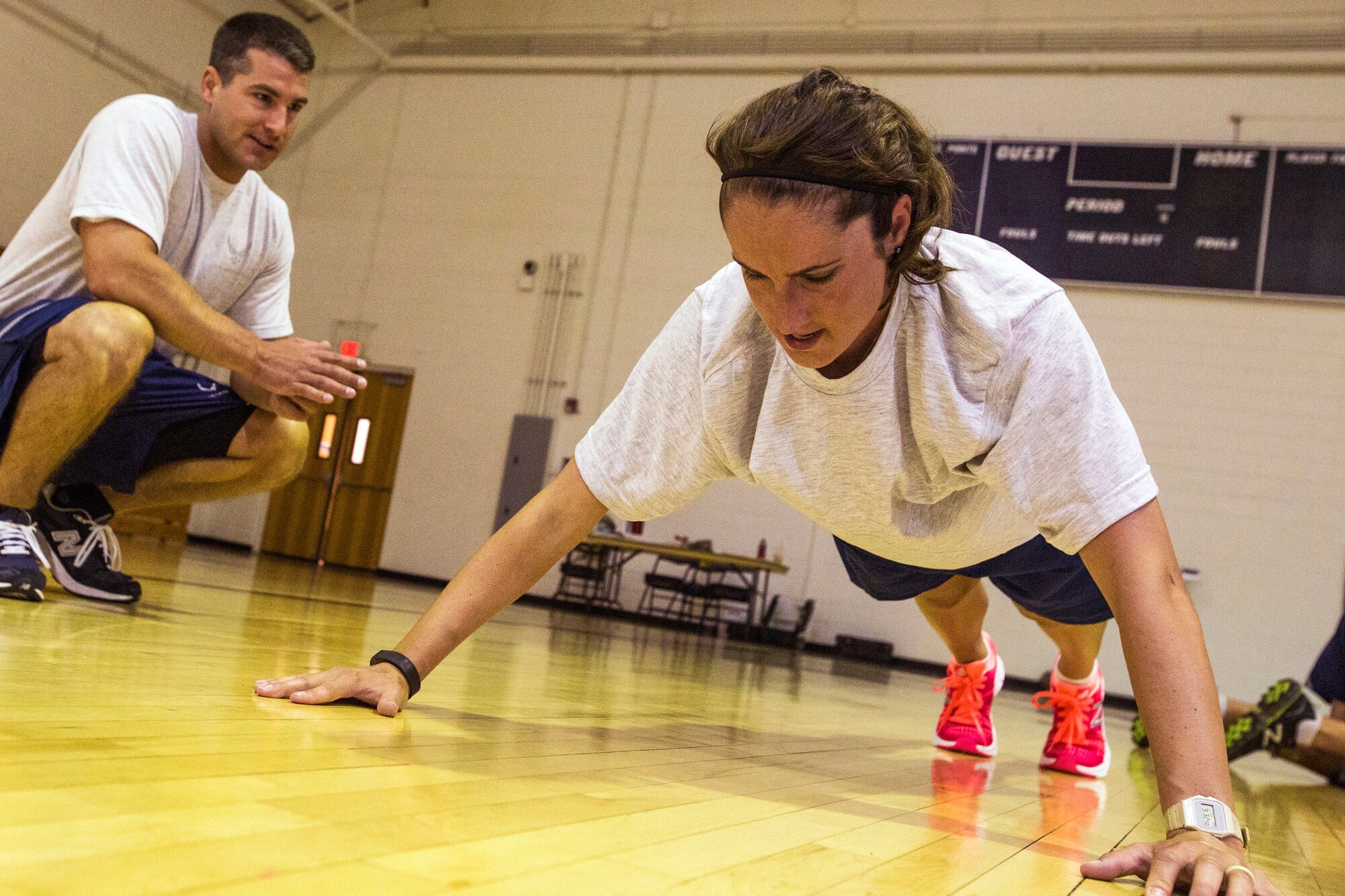 Senior Airman Andrew C. King, left, counts Senior Airman Ashley V. Chytraus’s pushups during the United States Air Force Fitness Test at Joint Base McGuire-Dix-Lakehurst, N.J., June 14, 2015. Both King and Chytraus serve in the 108th Wing, New Jersey Air National Guard. Chytraus was in a motorcycle accident June 21, 2014. The collision broke two vertebrae in Chytraus’s neck, crushed her hand, mangled the quadriceps tendon in her leg, forced two splintered ribs into her liver and fractured her elbow. In addition, she died while being medevaced to the hospital. 358 days later, she passed all portions of the Air Force Physical Fitness Test and received an excellent. (U.S. Air Force photo by Master Sgt. Mark C. Olsen/Released)