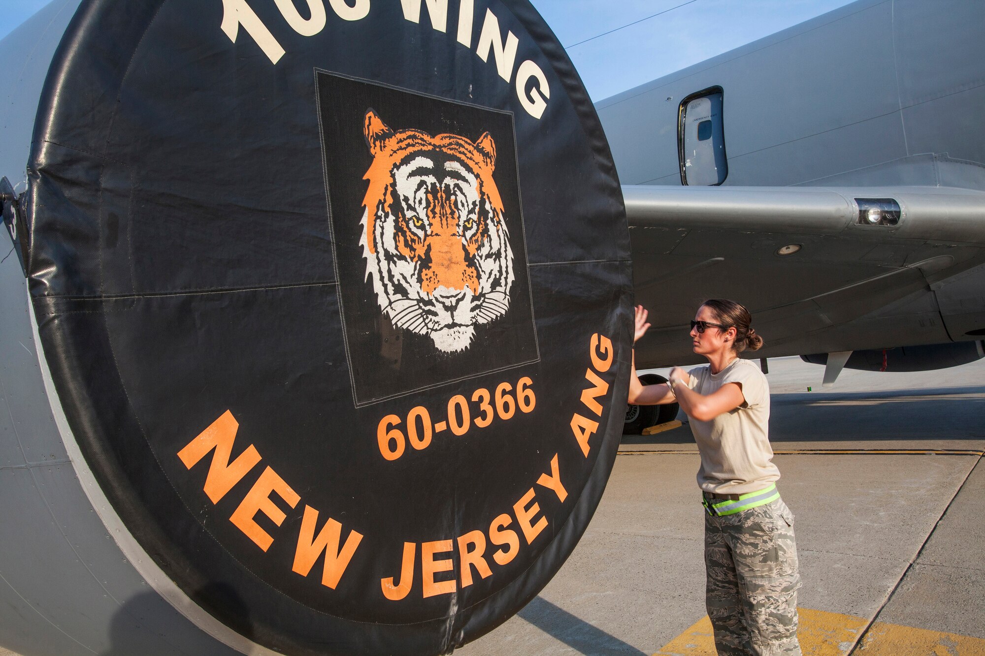 Senior Airman Ashley V. Chytraus, a crew chief with the 108th Wing, New Jersey Air National Guard, attaches an engine cover on a KC-135R Stratotanker at Joint Base McGuire-Dix-Lakehurst, N.J., June 11, 2015. Chytraus was in a motorcycle accident June 21, 2014. The collision broke two vertebrae in Chytraus’s neck, crushed her hand, mangled the quadriceps tendon in her leg, forced two splintered ribs into her liver and fractured her elbow. In addition, she died while being medevaced to the hospital. 358 days later, she passed all portions of the Air Force Physical Fitness Test and received an excellent. (U.S. Air Force photo by Master Sgt. Mark C. Olsen/Released)