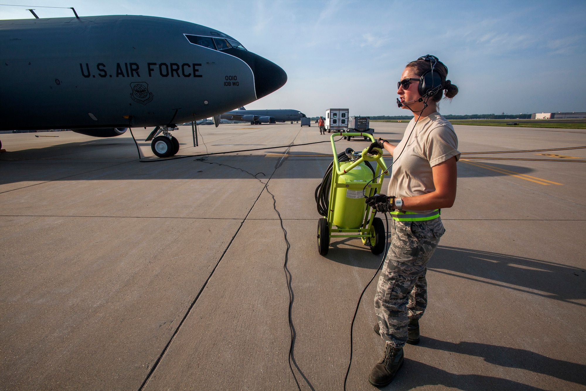 Senior Airman Ashley V. Chytraus, a crew chief with the 108th Wing, New Jersey Air National Guard, stands by as a KC-135R Stratotanker starts its engines for a training flight at Joint Base McGuire-Dix-Lakehurst, N.J., June 11, 2015. Chytraus was in a motorcycle accident June 21, 2014. The collision broke two vertebrae in Chytraus’s neck, crushed her hand, mangled the quadriceps tendon in her leg, forced two splintered ribs into her liver and fractured her elbow. In addition, she died while being medevaced to the hospital. 358 days later, she passed all portions of the Air Force Physical Fitness Test and received an excellent. (U.S. Air Force photo by Master Sgt. Mark C. Olsen/Released)
