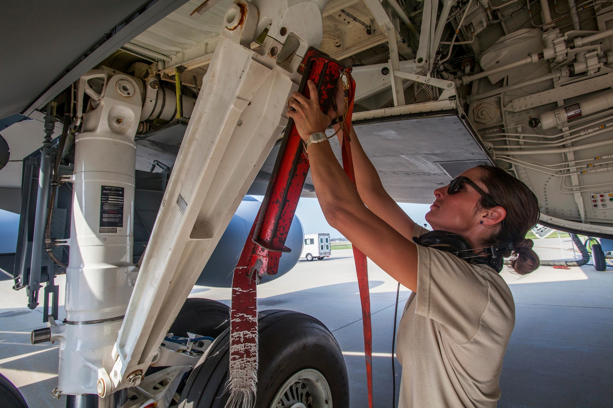 Senior Airman Ashley V. Chytraus, a crew chief with the 108th Wing, New Jersey Air National Guard, prepares a KC-135R Stratotanker for a training flight at Joint Base McGuire-Dix-Lakehurst, N.J., June 11, 2015. Chytraus was in a motorcycle accident June 21, 2014. The collision broke two vertebrae in Chytraus’s neck, crushed her hand, mangled the quadriceps tendon in her leg, forced two splintered ribs into her liver and fractured her elbow. In addition, she died while being medevaced to the hospital. 358 days later, she passed all portions of the Air Force Physical Fitness Test and received an excellent. (U.S. Air Force photo by Master Sgt. Mark C. Olsen/Released)