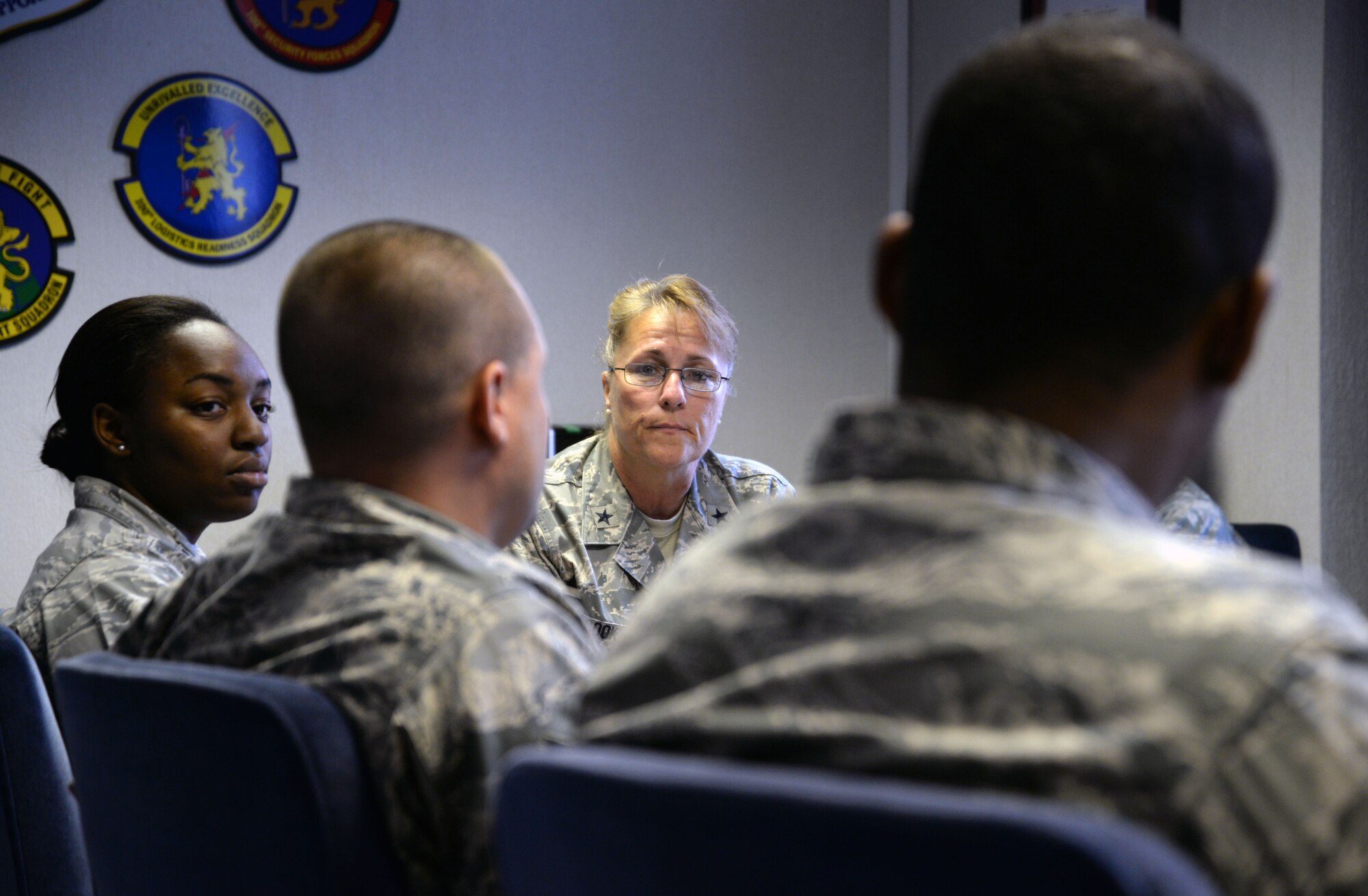 U.S. Air Force Brig. Gen. Kathleen A. Cook, center, Director of Public Affairs, Office of the Secretary of the Air Force, the Pentagon, Washington, D.C., listens to an Airman’s question during a meet and greet session with the 100th Air Refueling Wing Public Affairs office June 24, 2015, on RAF Mildenhall, England. Cook and Jerry Renne, Director of Public Affairs and Communication, Headquarters, U.S. Air Forces in Europe, U.S. Air Forces Africa, visited Public Affairs offices in the local area to answer Airmen’s questions and concerns within their career field. (U.S. Air Force photo by Senior Airman Christine Halan/Released)