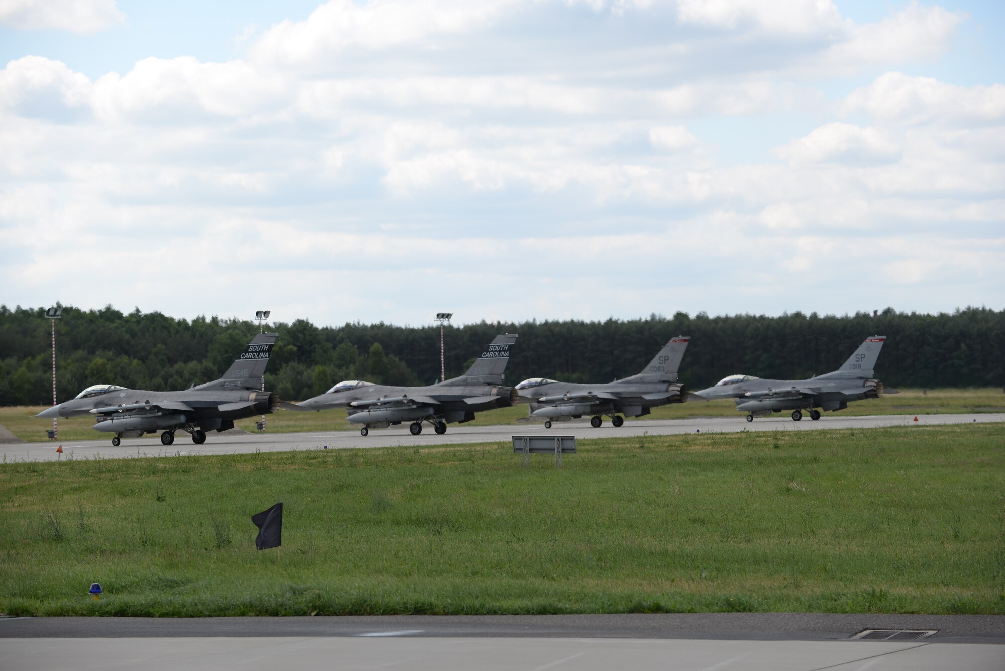The U.S. Air Force, along with its Polish counterparts leave Łask Air Base to participate in exercise Eagle Talon with the first F-16 flights from the South Carolina  Air National Guard, 52nd  Fighter Wing and the 32nd Tactical Wing from Poland, June 16, 2015. U.S. Air Force Airmen from Spangdahlem Air Base, Germany and the South Carolina Air National Guard’s 169th Fighter Wing from McEntire Joint National Guard Base, are deployed to Łask Air Base in support of Operation ATLANTIC RESOLVE, during the month of June. These training missions, called Aviation Detachment Rotations, pair U.S. fighter pilots and maintenance crews with their Polish air force counterparts at Łask Air Base. This bilateral training, hosted by permanently assigned USAF service members assigned to Poland, has taken place since 2012. Through strengthened relationships and engagements with our allies, the U.S. and NATO demonstrate their shared commitment to a peaceful, stable and secure Europe. (U.S. Air Force photo by Senior Master Sgt. Wesley Fleming /Released)