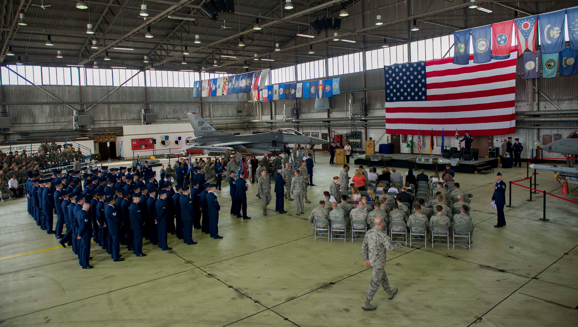 Members of the Spangdahlem community attend the 52 MXG change of command ceremony in hangar one on Spangdahlem Air Base, Germany, June 18, 2015. Base leadership, honorary base commanders, local nationals and friends and families of the outgoing MXG commander were also in attendance. (U.S. Air Force photo by Airman 1st Class Timothy Kim/Released)