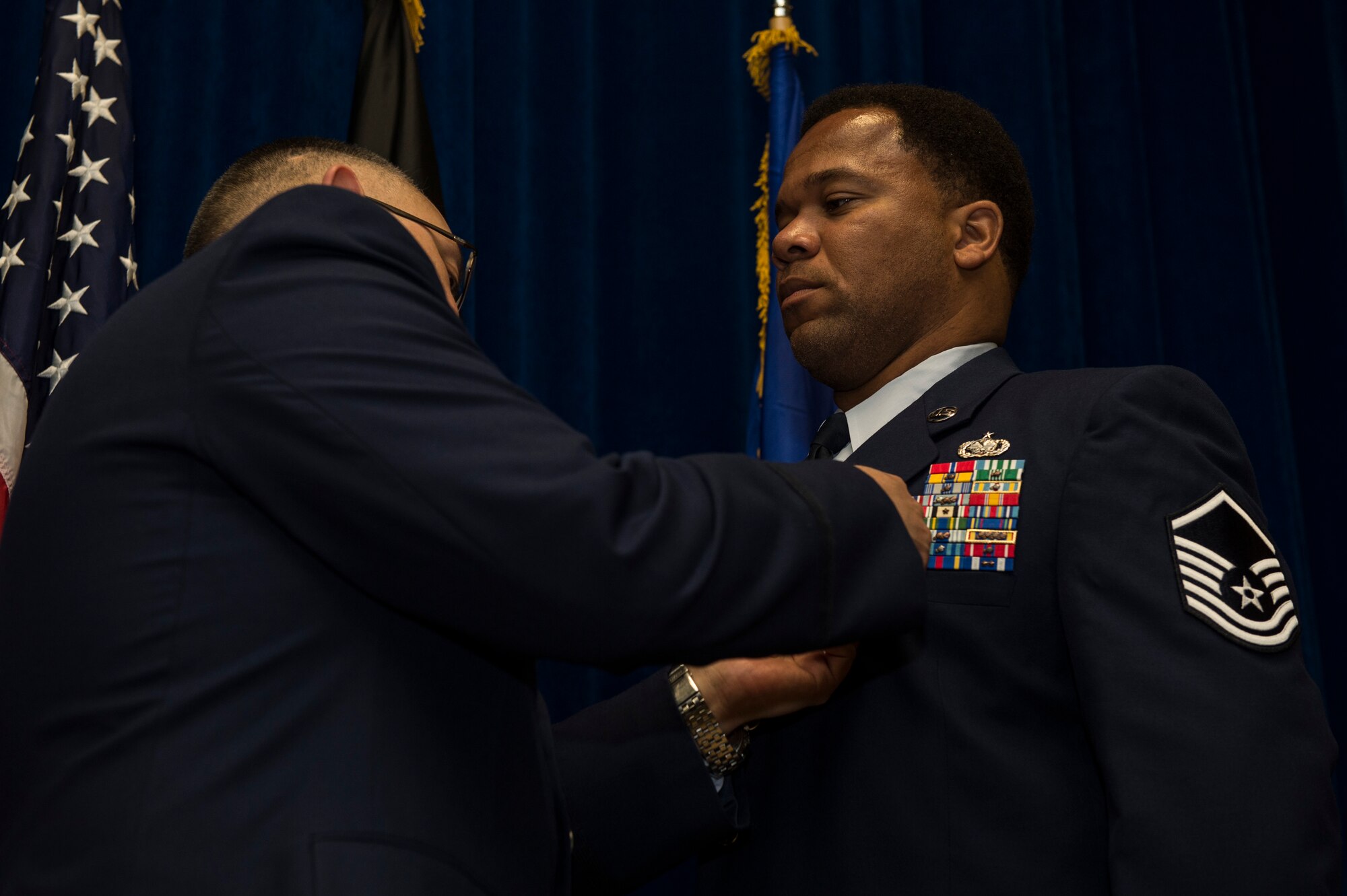 U.S. Air Force Master Sgt. Greer Stevenson, 52nd Fighter Wing Safety Office motorcycle safety program manager, receives the Bronze Star Medal from U.S. Air Force Col. Drysdale Hernandez, 52nd Mission Support Group commander during an award presentation at the Brick House on Spangdahlem Air Base, Germany, June 24, 2015. Stevenson received the award for his service during a 2014 deployment as a Class VII rolling stock logistics advisor in support of Operation Enduring Freedom. (U.S. Air Force photo by Staff Sgt. Christopher Ruano/Released)